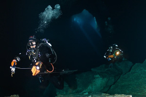 Divers enter the lower section of Kilsby's Sinkhole.  Dep... by Mick Tait 
